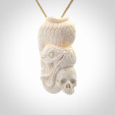 Hand carved bone snake skull pendant. Hand carved by NZ Pacific. Free postage worldwide. Hand made snake with skull necklace from bone. Snake skull necklace for men and women.